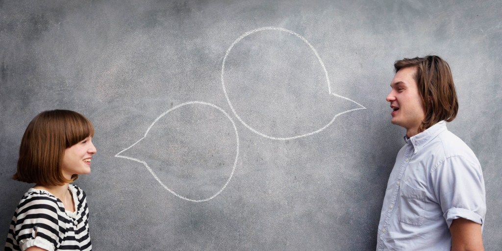 man and woman with speech bubbles on chalk board