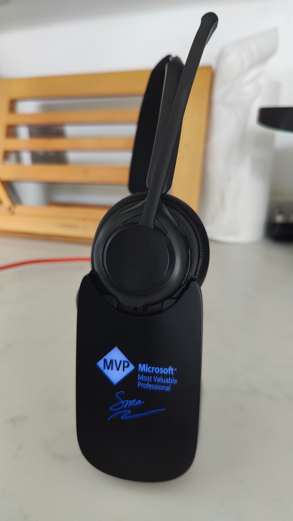 Blucalm INSIGHT50 headset on its dock, with a blue illuminated MVP branded faceplate